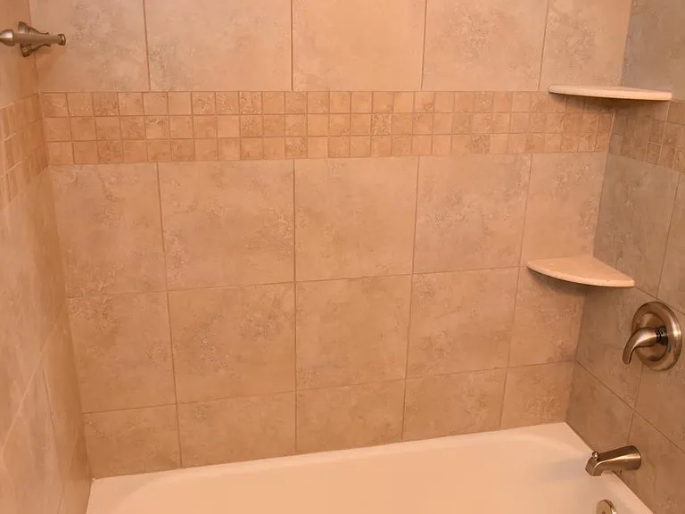 Bath: Porcelain tile & tub, Moen bath & shower fixtures, towel rod, toiletry shelves, linen closet