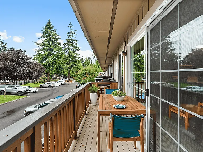 Unwind on this serene balcony with picturesque views and cozy seating.