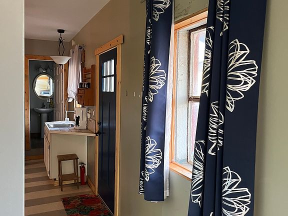 looking down hallway toward kitchen from bedroom
