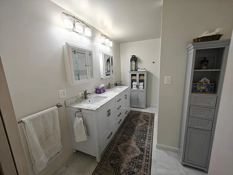 Master Bathroom with double sink marble vanity, marble tile.