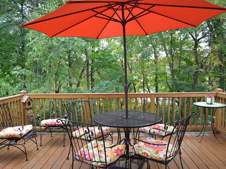 Spacious deck with stairs to the backyard.