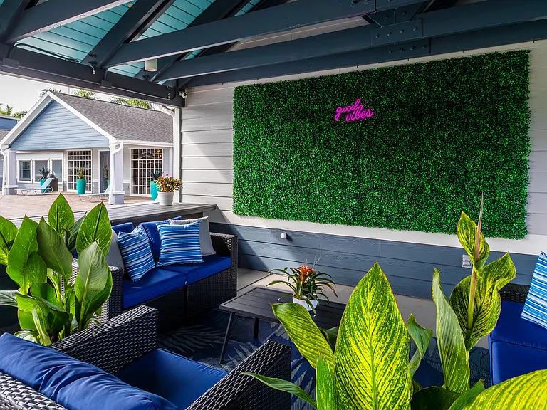 Sink into our comfortable outdoor lounge seating surrounded by lush greenery and playful decor designed to create the ultimate laid-back vibe.