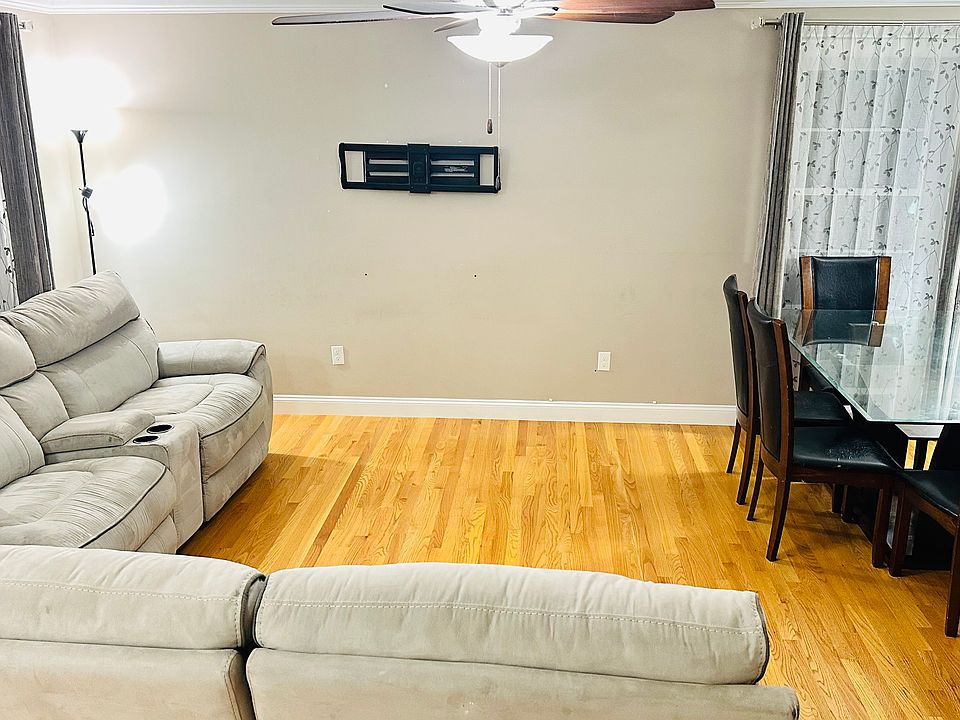 Living Room with sectional sofa, TV wall mount and dining table