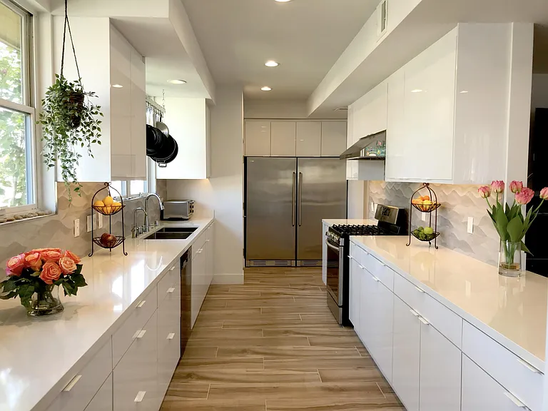 Gourmet Chef's custom kitchen with oversized double sink, full fridge & full freezer, 6-burner gas stove/oven, and various custom built-in cabinets & pull-outs to store spices, teas, coffees, utensils, knives, pots & pans, and still have room for entertai