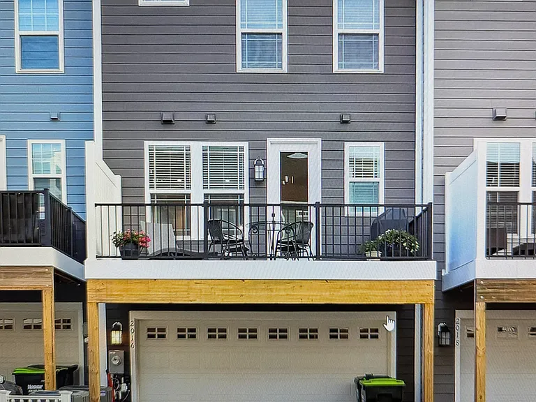 REAR-load OVERSIZED 2 car garage, elevated trex-deck, 4 reserved-parking spaces conveniently outside your back door. 
Trash picked up from the back by the HOA.