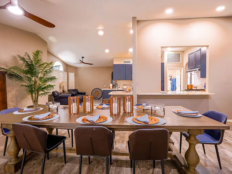 Open plan living room, dining room, kitchen, entry way.
Living room has 2 leather couches with queen size hide away bed, dining table seats 10, sliding door to patio seating