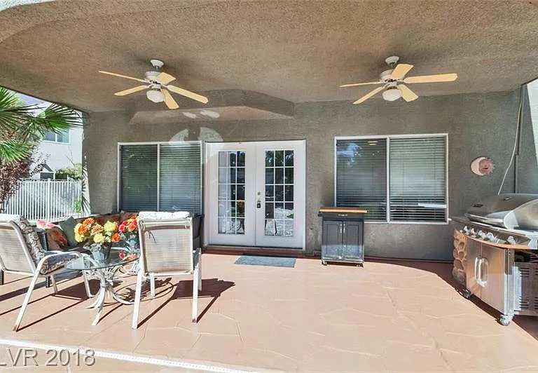 Outside covered patio, barbeque, built-in table,2 ceiling fans.