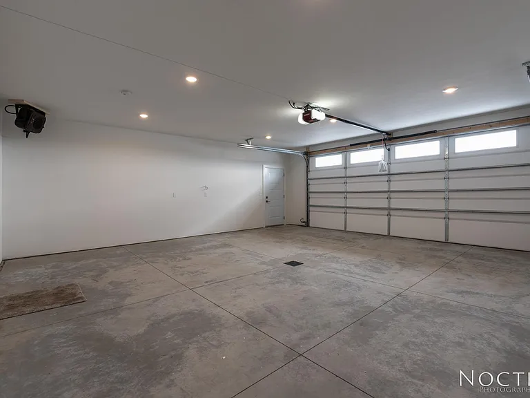 Extra large garage. (Photo of another unit with similar finishes and quality.)