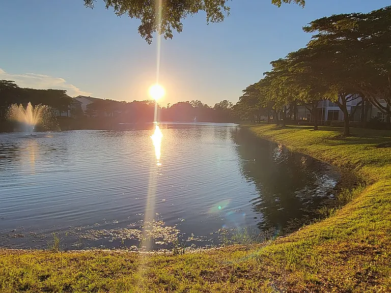 Wake up to serene lakefront views framed by mature trees and manicured landscaping.