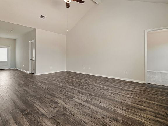 A foyer welcomes guests into a spacious family room