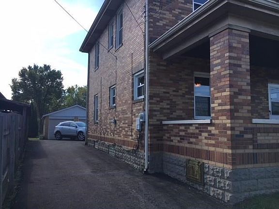 Left side showing newly paved asphalt driveway.