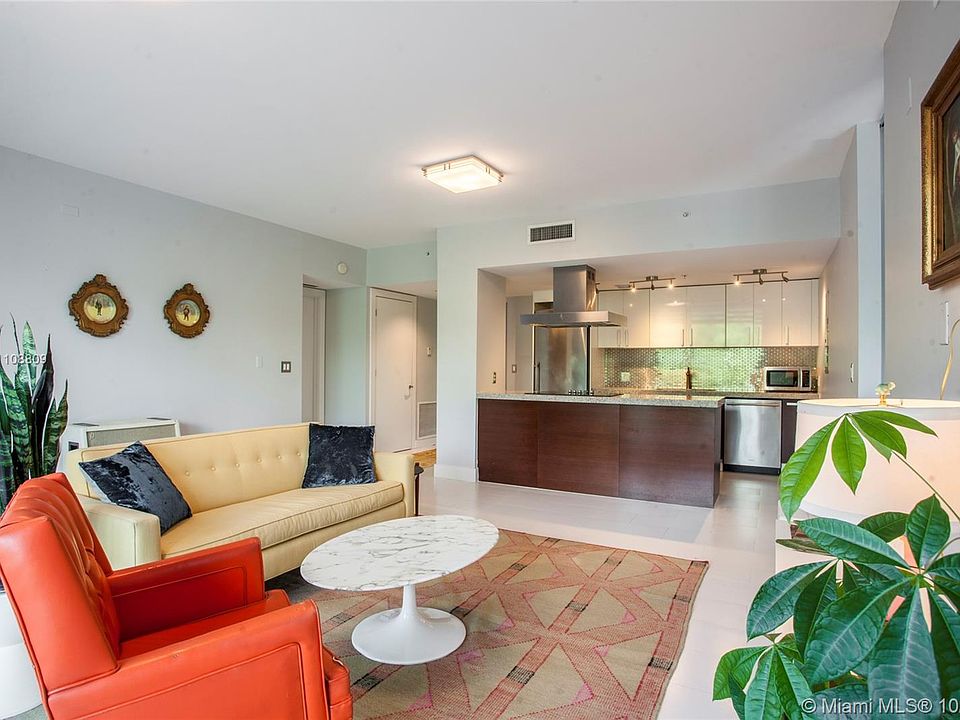 Living room with adjacent open kitchen design.