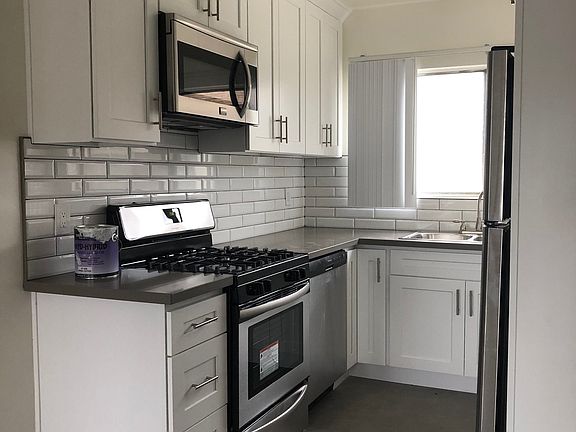 Kitchen with refridgerator to the right.