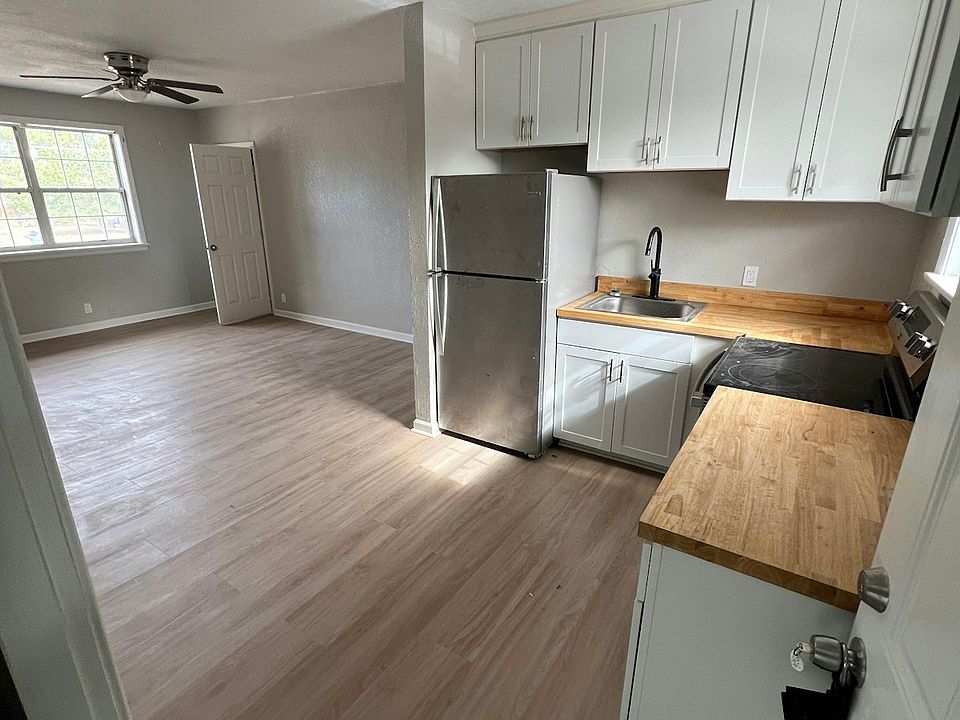 Kitchen Brand new cabinetry with stainless steel appliances and durable butcher-block countertops.