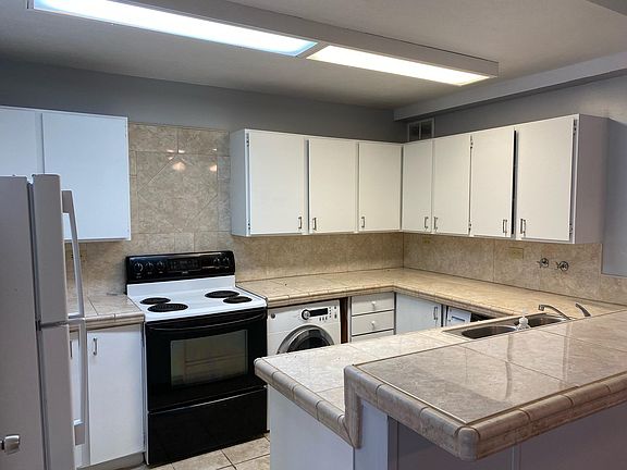 Kitchen with stove, fridge, washer, dryer, and dishwasher