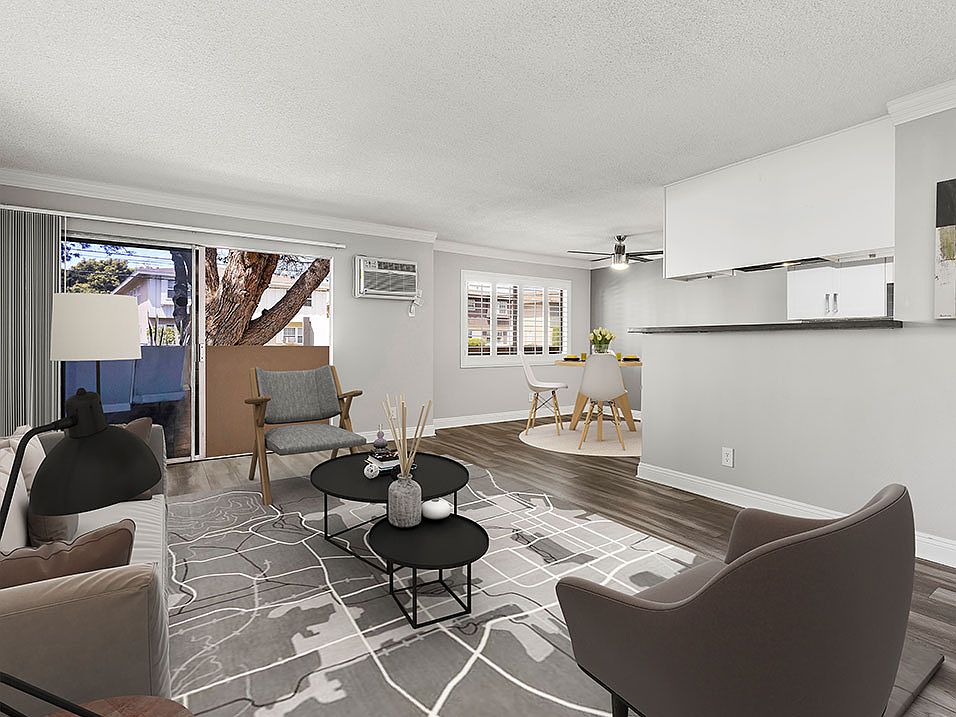 Hardwood floored living room with view of dining area.