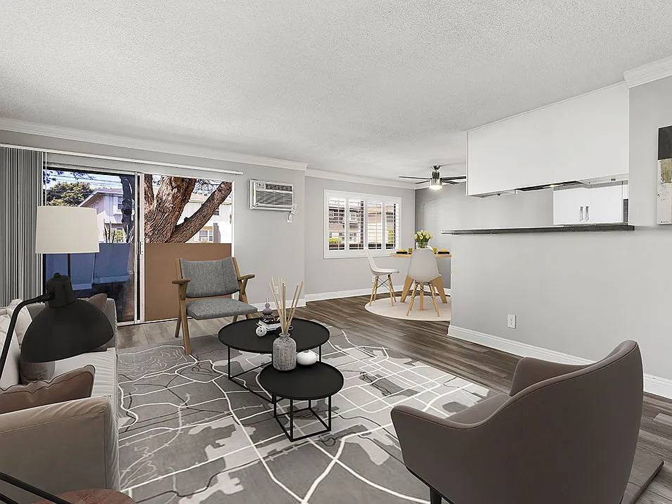Hardwood floored living room with view of dining area.