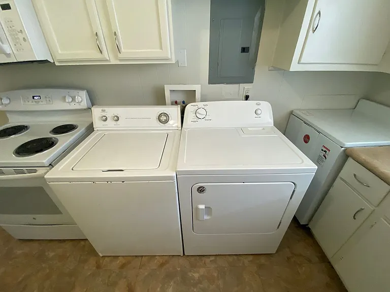 Private carport, in-unit laundry, and the Lakewood strip right outside your door. — Photo 8