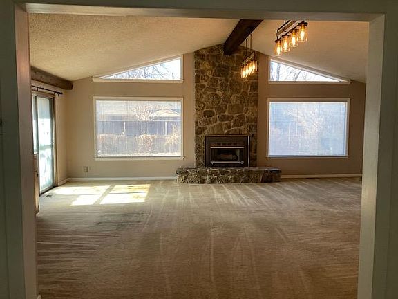 Large den off the back of the house with gas fireplace