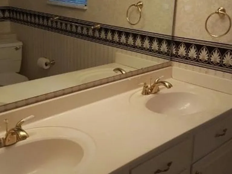 Master bathroom sinks, with window to pool area.