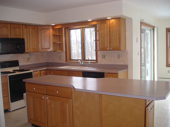 Kitchen is bright and has lots of cupboards.