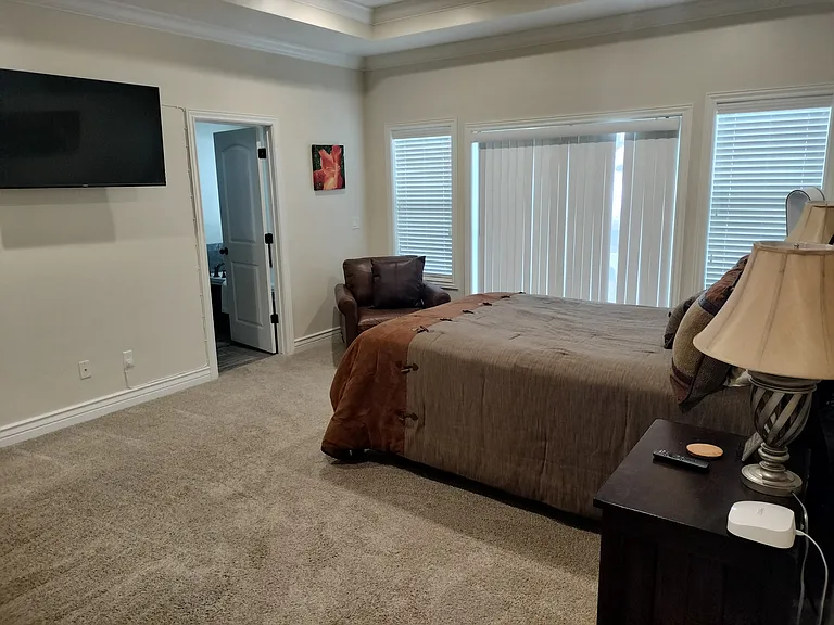 Master bedroom features a new Kingsdown queen bed, Smart TV, walk in closet, private walk-out deck with attached hot tub and pergola (to be installed before move-in). Enjoy luxury, privacy, and mountain views in this spacious retreat.