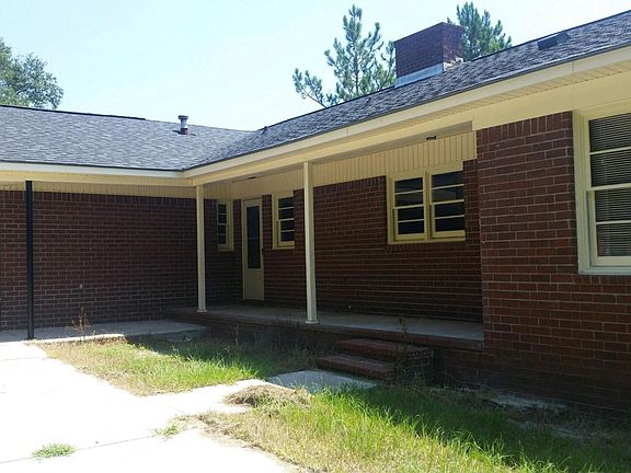 Back of house with double carport and back porch