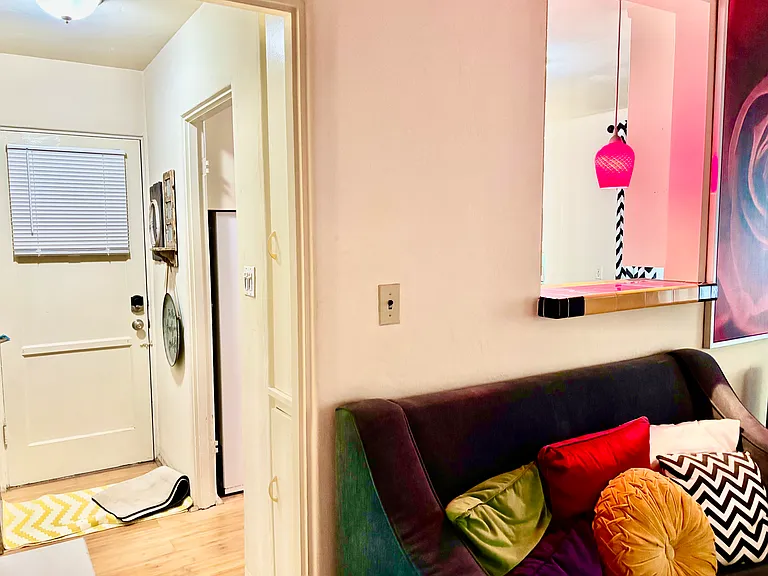 Hallway from living room and bedroom to bathroom and kitchen. Also a back door!