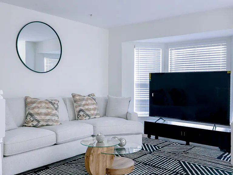Bright and inviting living room with abundant natural light, modern finishes, and beautiful hardwood flooring_perfect for relaxing or entertaining.