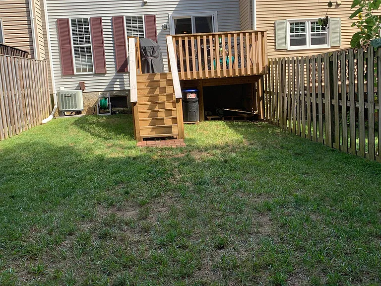 New deck with gate and fenced in backyard
