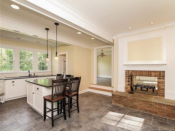 Kitchen with island and fir...