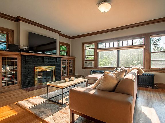 Living room with original built-ins, lots of sunlight and wo