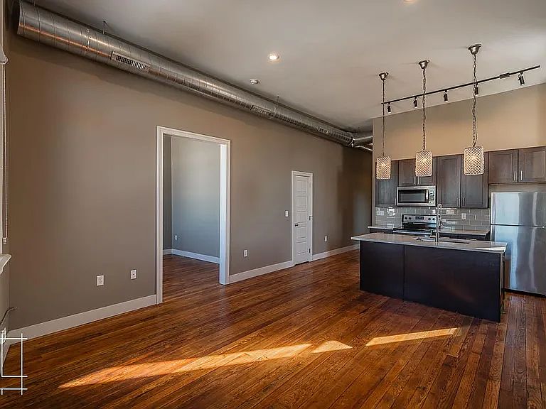 Light filled kitchen and living room, with a view of the office (third bedroom) on the left
