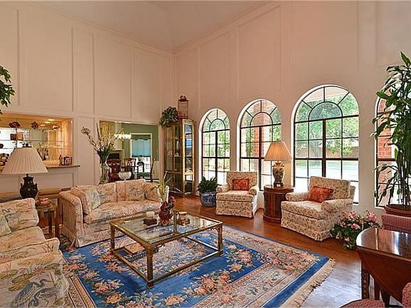 Everyone will be captivated by the spacious living area with its stunning view of the pool and yard as seen through the floor to ceiling double pane windows.