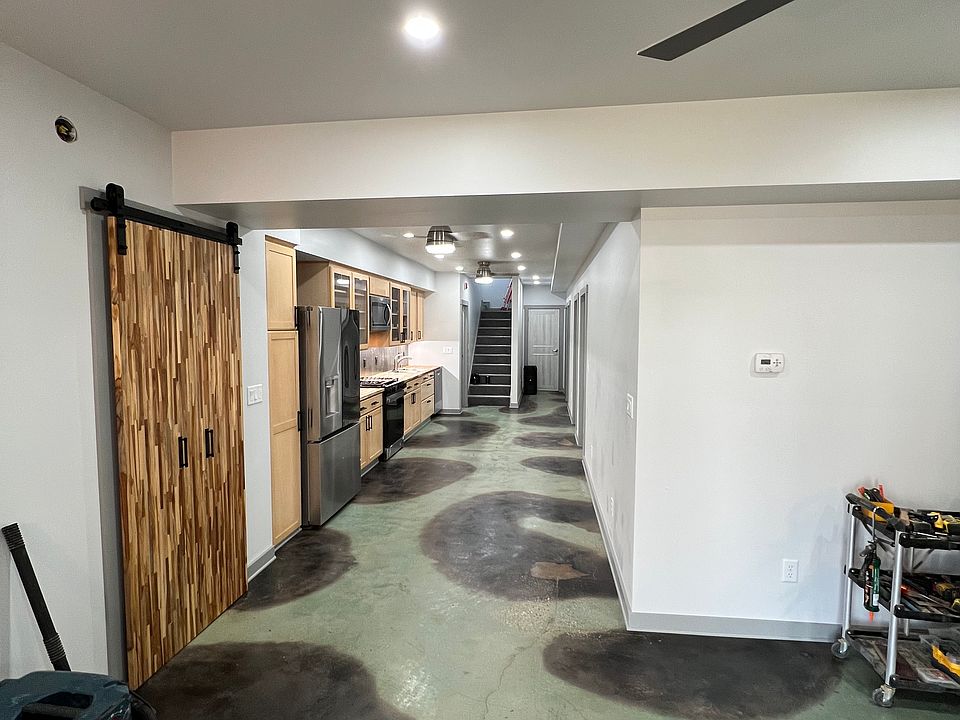 Living are looking through kitchen to entry stairs