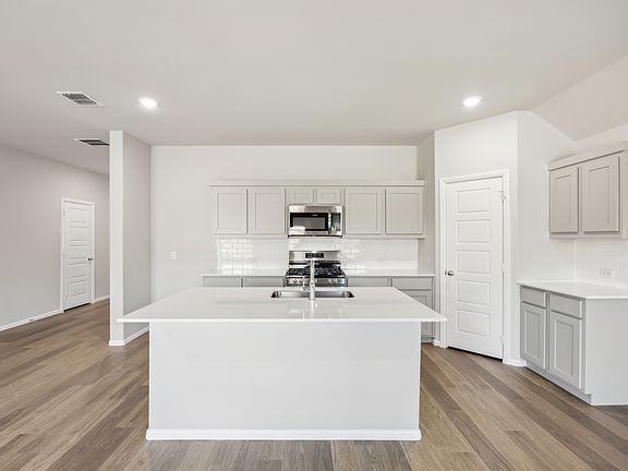 Kitchen in the Hadley home plan by Trophy Signature Homes - REPRESENTATIVE PHOTO