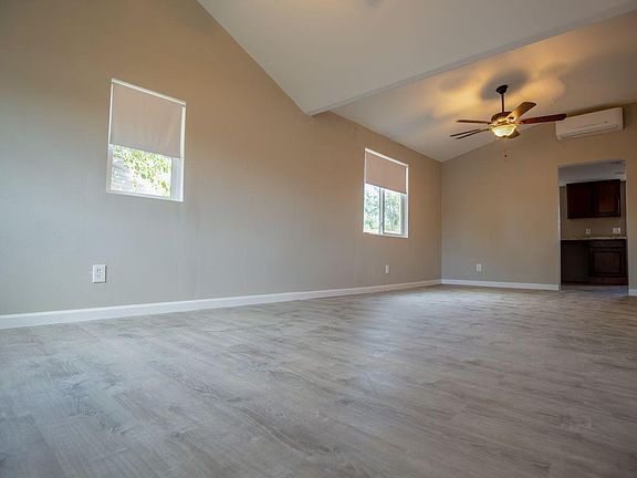 Living room. Wood floors, ceiling fans, vaulted ceiling.