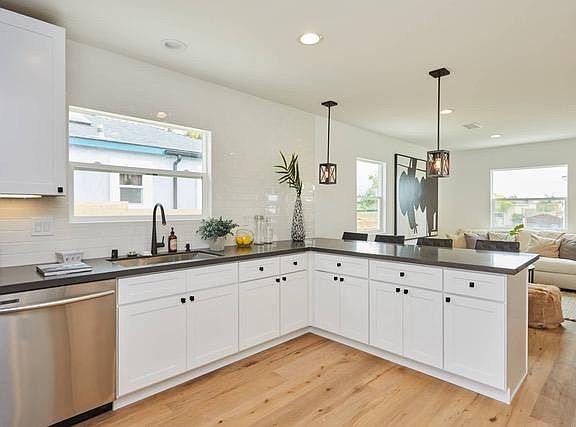 Designer kitchen with all new stainless appliances and wall 