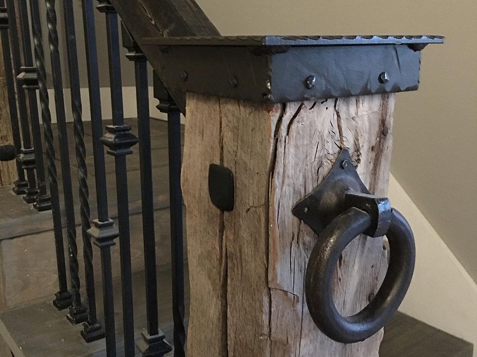 Hitching post with custom made iron cap welcome you into the entry