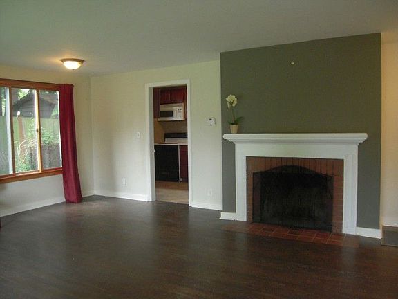 Charming Living Room With Fireplace and Hardwood Floors