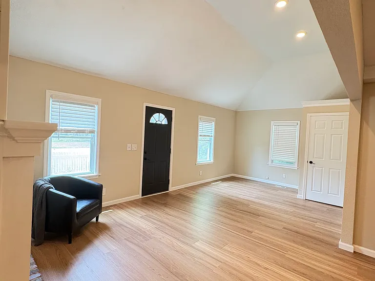 Spacious family room featuring ample storage, fresh paint, and brand-new flooring.