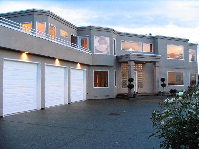 Photo of the front of the home. Lots of parking room & space. 9â?? garage doors, hot & cold water to