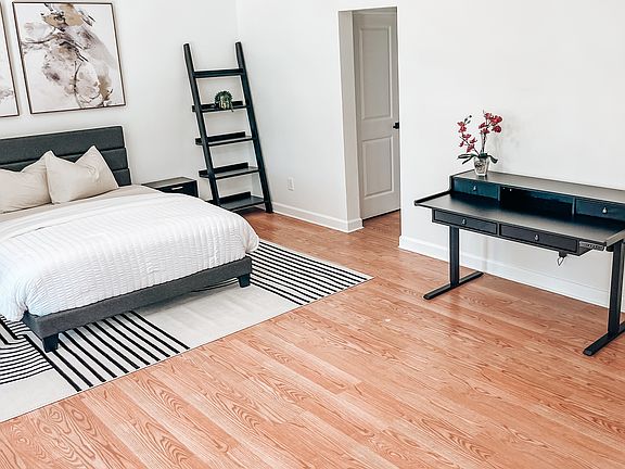 Comfortable bedroom with dedicated workspace for remote work or study.