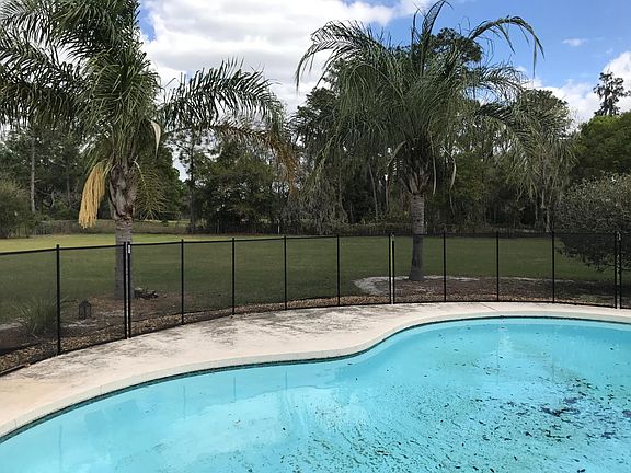Pool with partially fenced backyard