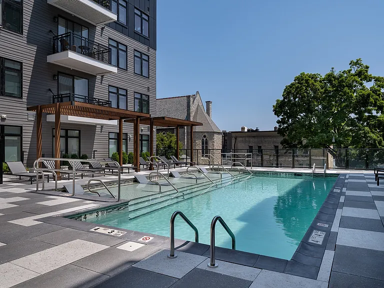 Luxurious resort-style pool courtyard with lounge areas.