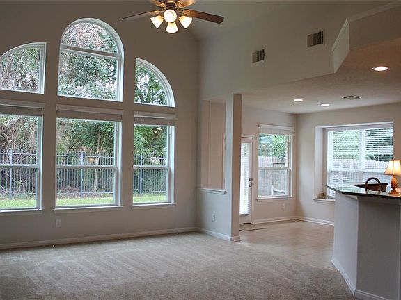 High ceilings and open spaces with lots of windows brighten the home.