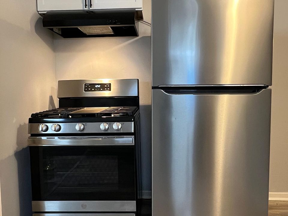 New Frigidaire stainless steel fridge & new GE gas stove. New range hood with light & small cabinet.