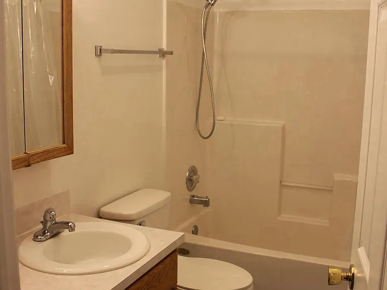 Clean bathroom with new toilet.
