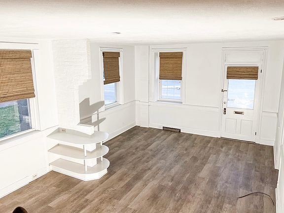 another view of the bright living room with lots of windows.