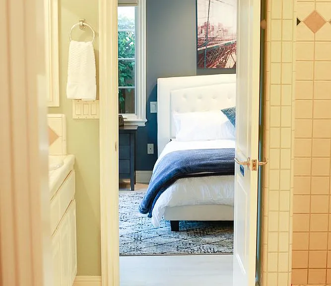 Perspective from the master bathroom facing the bedroom area.